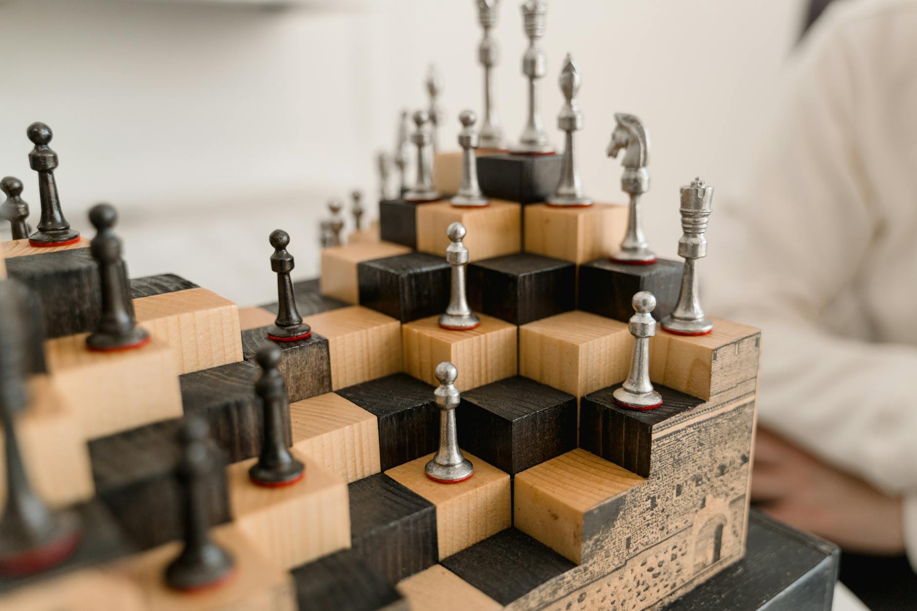 iron chess pieces on a wooden chessboard