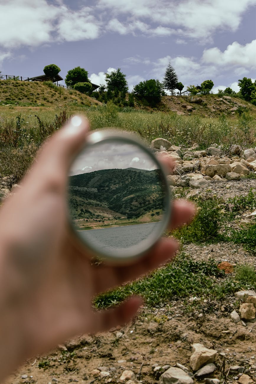 landscape reflecting in a small round hand mirror